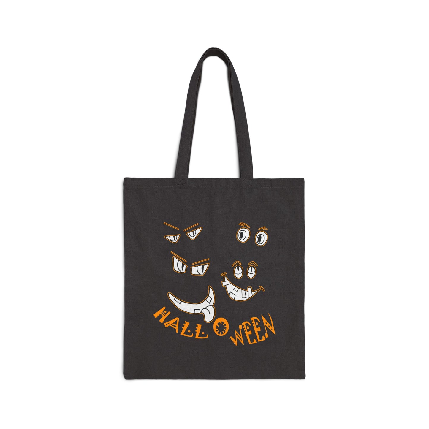 Halloween cut out faces peer out of a Black Cotton Canvas Tote Bag by artist Marie Frederique