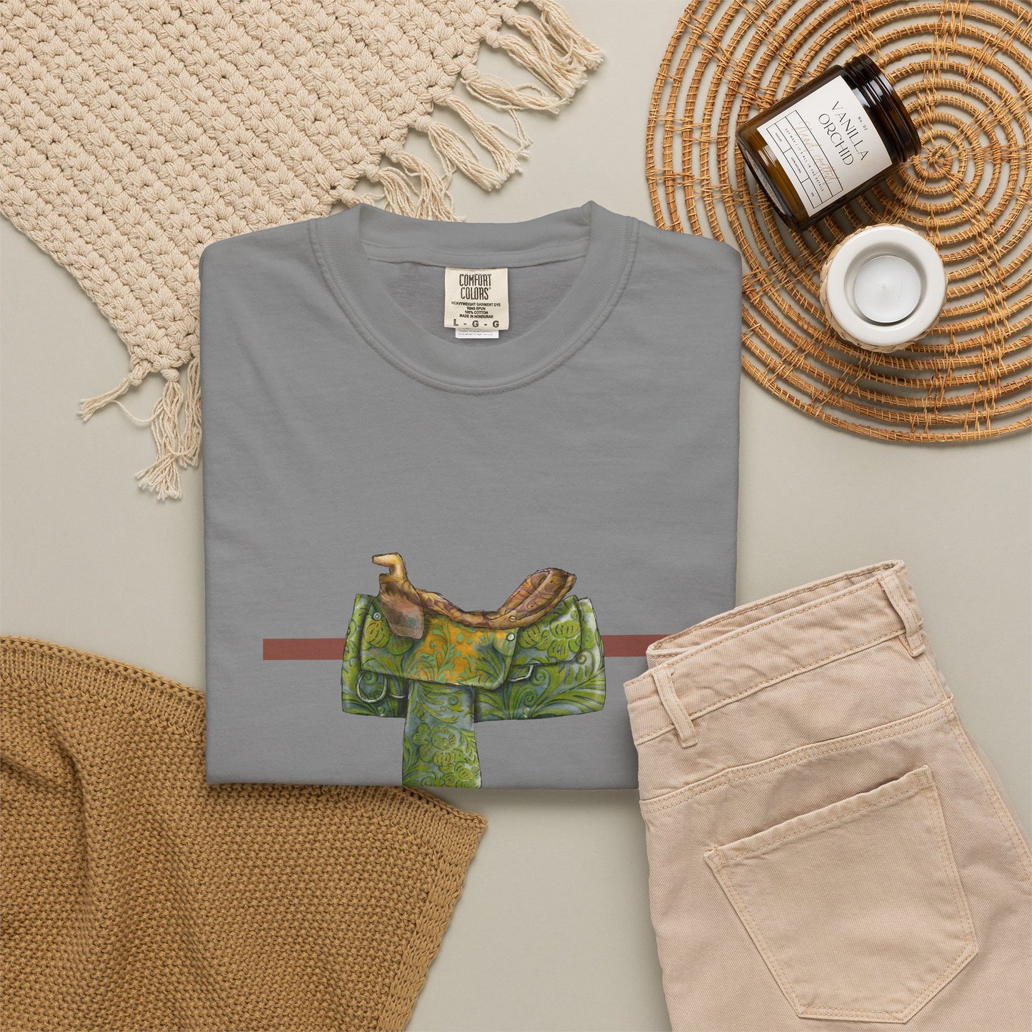 Western Saddle & Scarf Graphic T-Shirt — Rustic Western Equestrian Tee by artist Marie Frederique