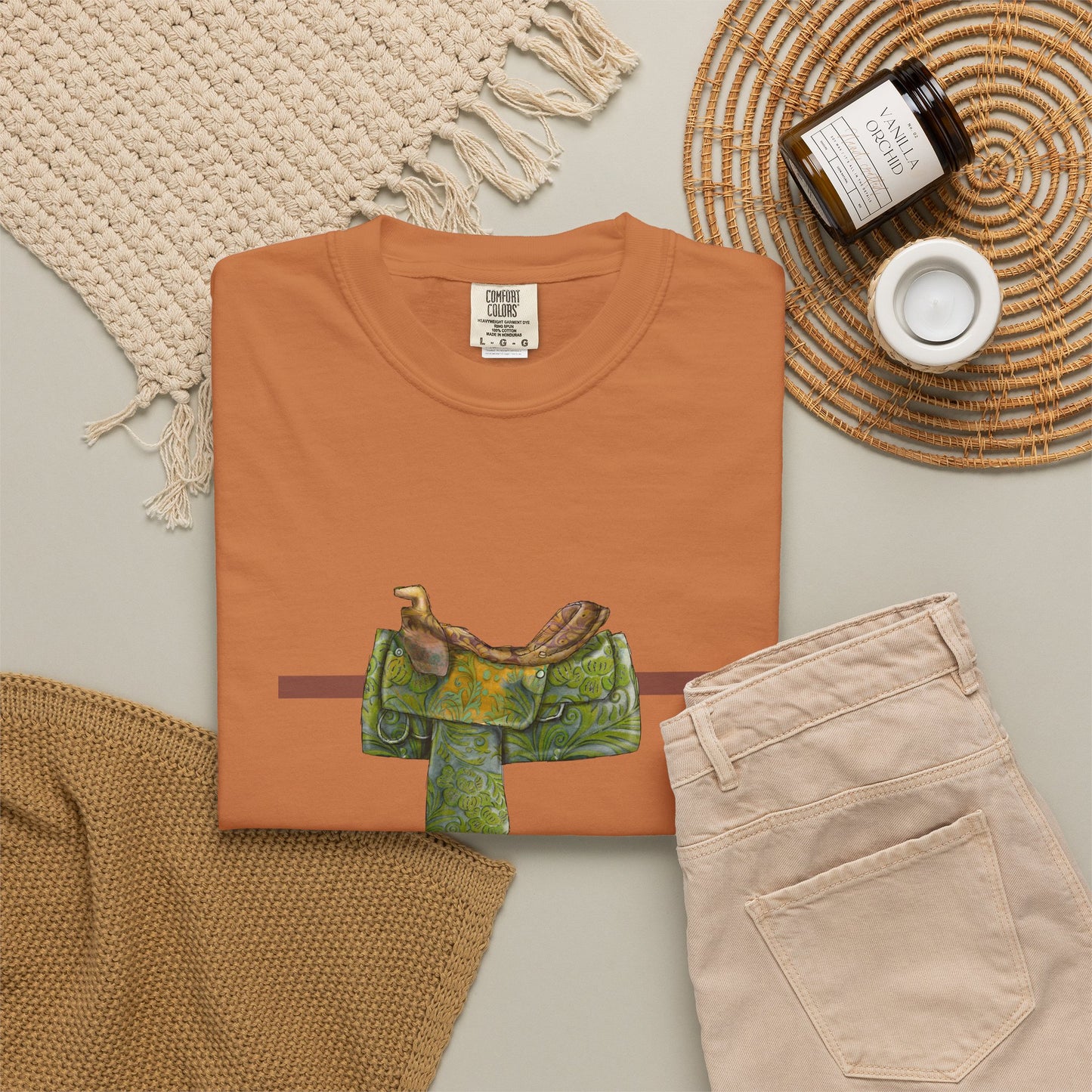 Western Saddle & Scarf Graphic T-Shirt — Rustic Western Equestrian Tee by artist Marie Frederique